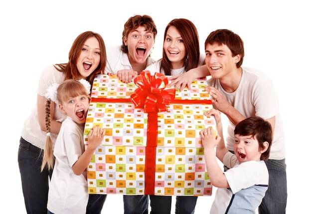 Lachende Familie mit großem Geschenk | © panthermedia.net / poznyakov
